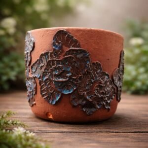 Handmade floral relief planter with deep blue flaze and textured botanical design.