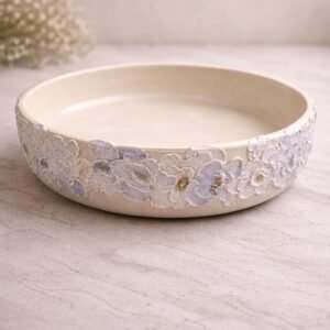 handmade pastel floral bowl with raised flower design and soft colours.