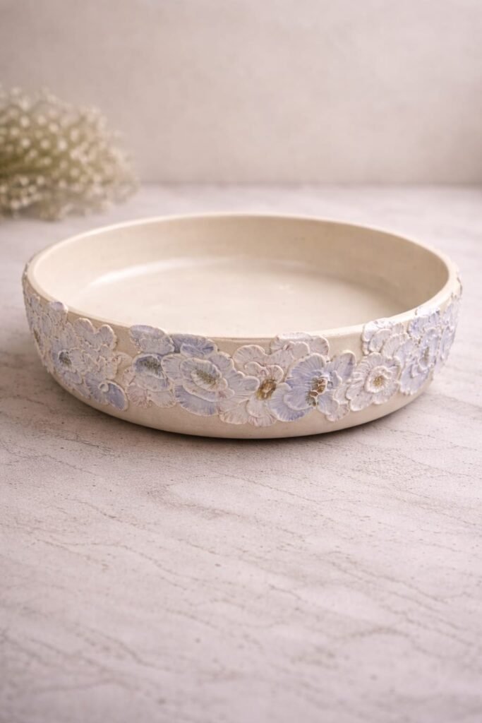 handmade pastel floral bowl with raised flower design and soft colours.
